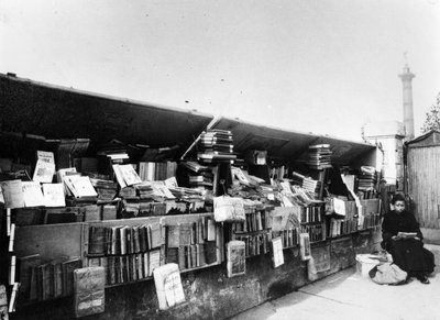 Bouquiniste beside the river Seine in Paris, c.1900 by French Photographer